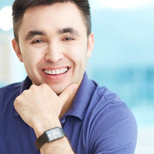 adult man in braces smiling