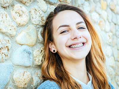 young adult girl smiling in braces